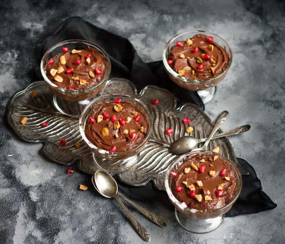 Chocolate Peanut Butter Pudding topped with chopped peanuts and pomegranate arils