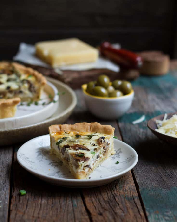 A slice of Mushroom Quiche | Mushroom Quiche with caramelized onions