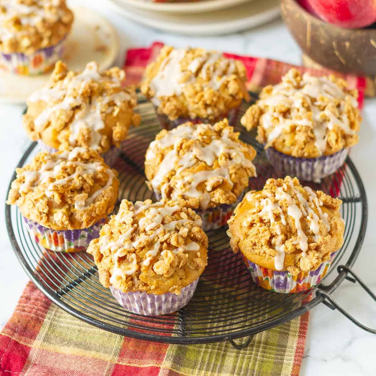 Muffins on a wire rack with a red napkin underneath.