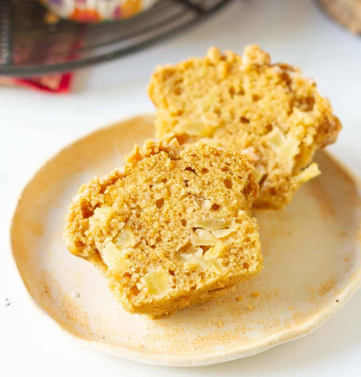 A muffin, halved, on a small plate to show the texture.