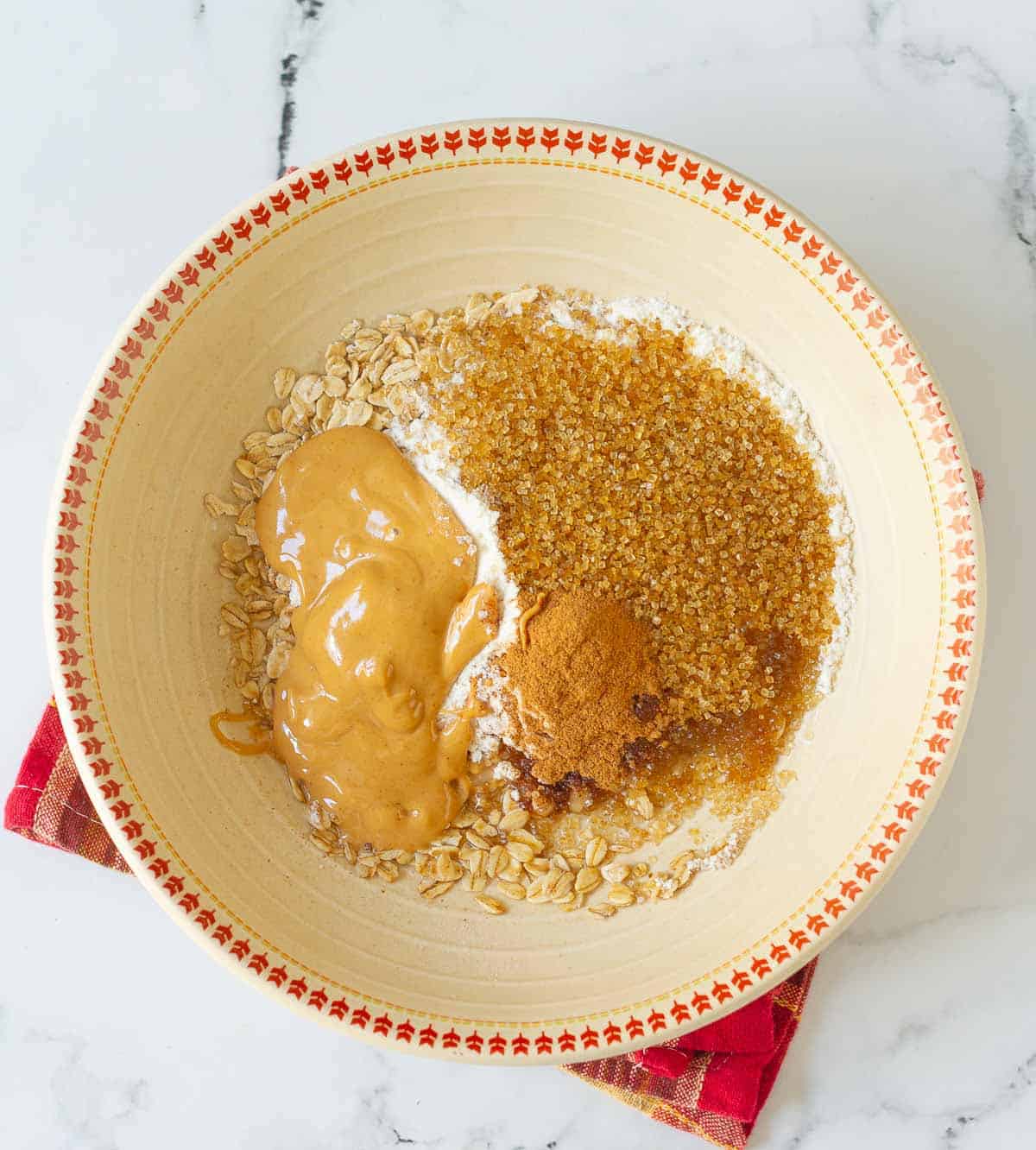Peanut butter, brown sugar, oil, and flour in a bowl.