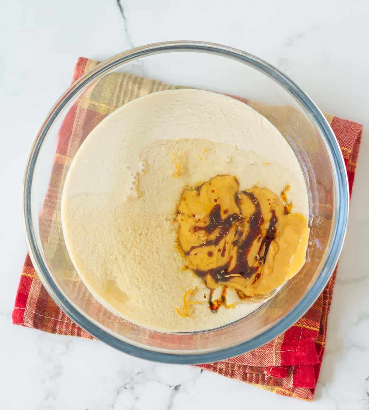 Milk, vanilla extract, peanut butter , and sugar in a mixing bowl.
