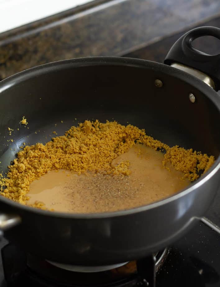 Add condensed milk and cardamom powder to the roasted besan ( chickpea flour)