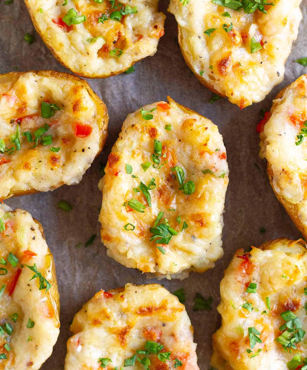 Baked potatoes topped with parsley and green onions.