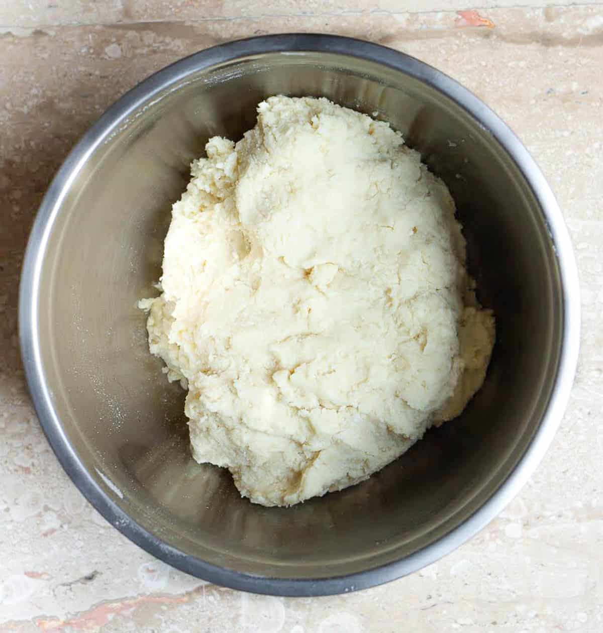 dough for Italian ricotta cookies in a mixing bowl.