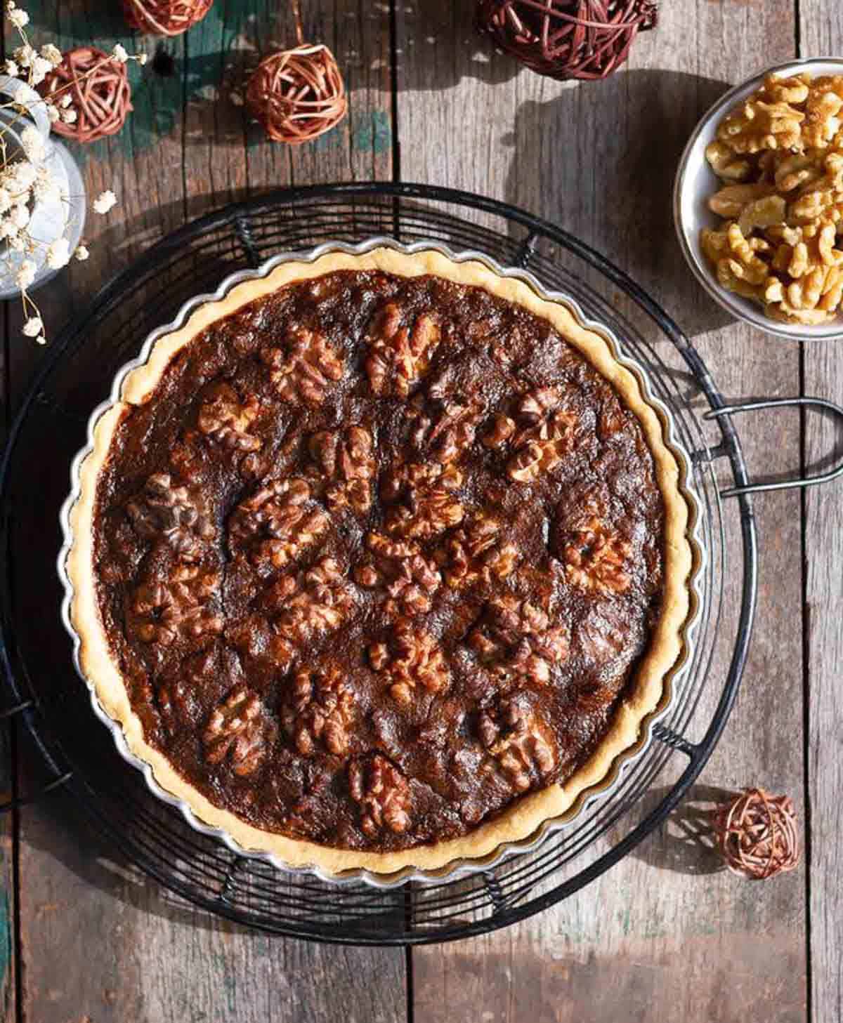 baked pie on a trivet with ingredients around.