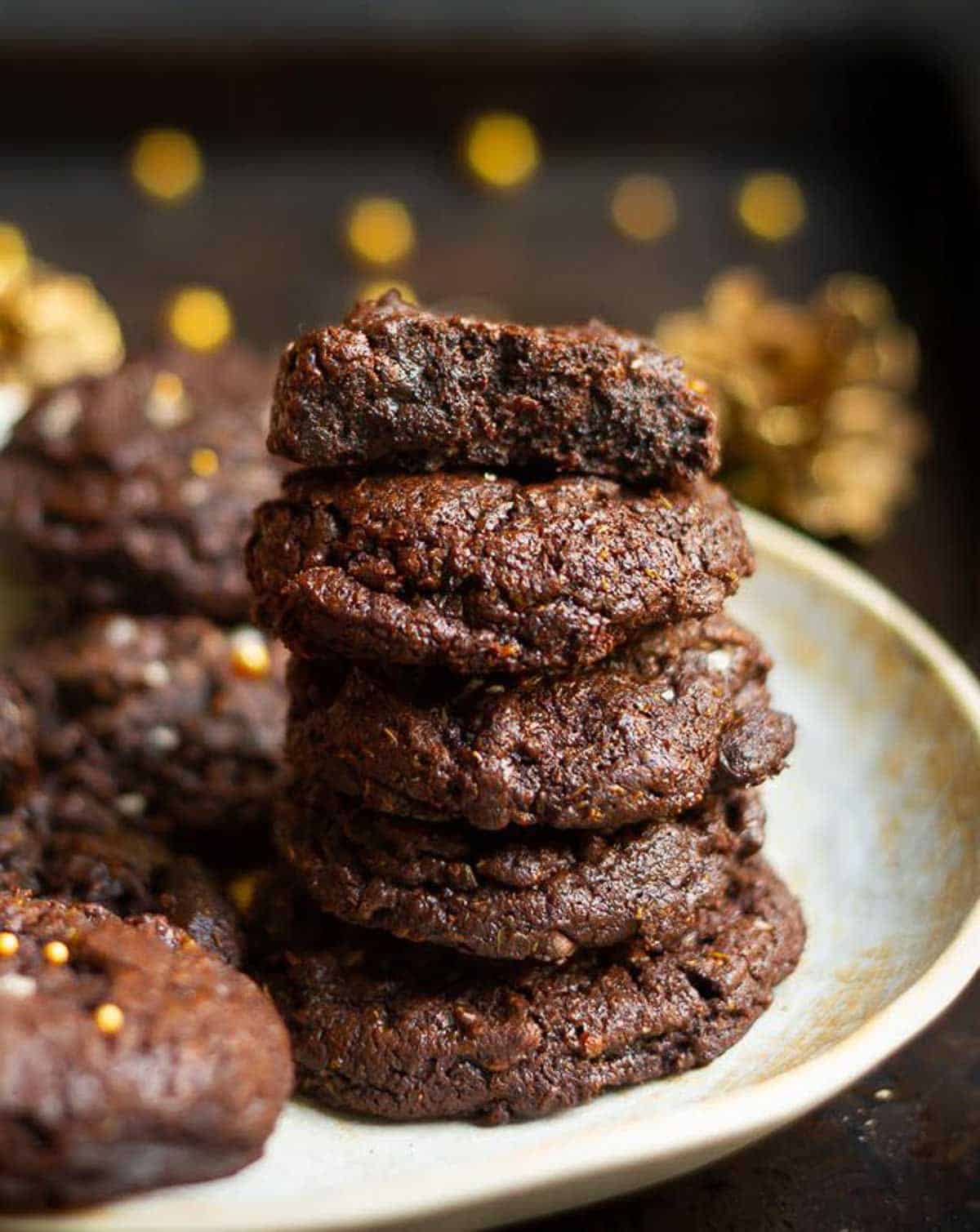 stack of cookies with one half cookie on top to show the fudgy center.