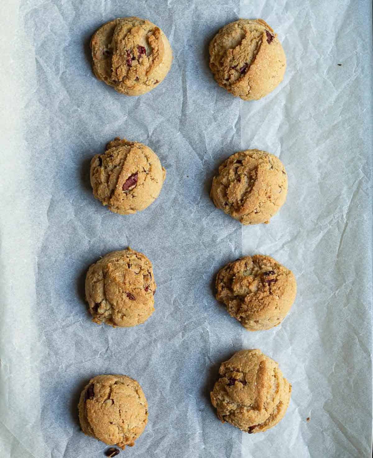 Baked cookies on a parchment-lined tray.