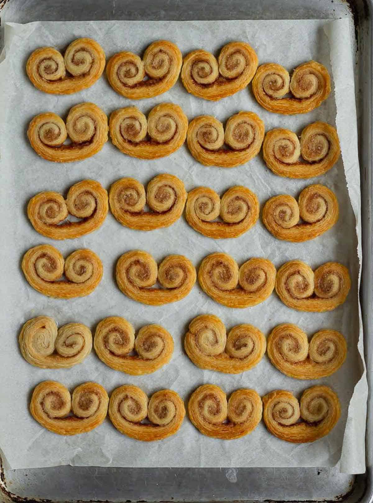 Baked French heart cookies on a baking tray.