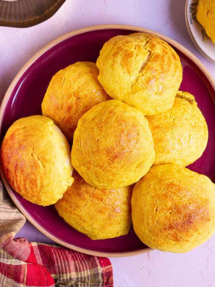 A red platter stacked with pineapple buns.