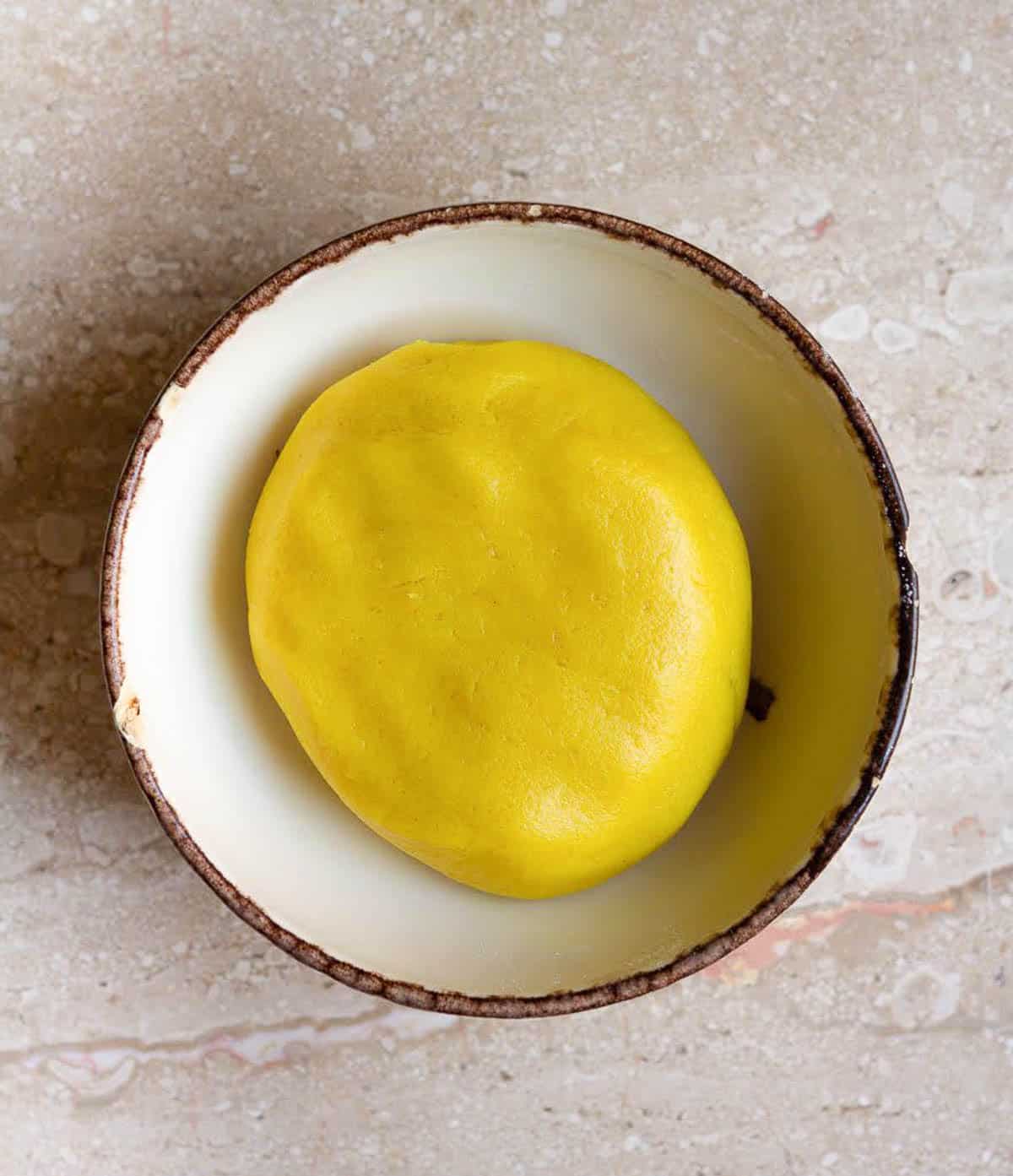 Yellow dough in a bowl.