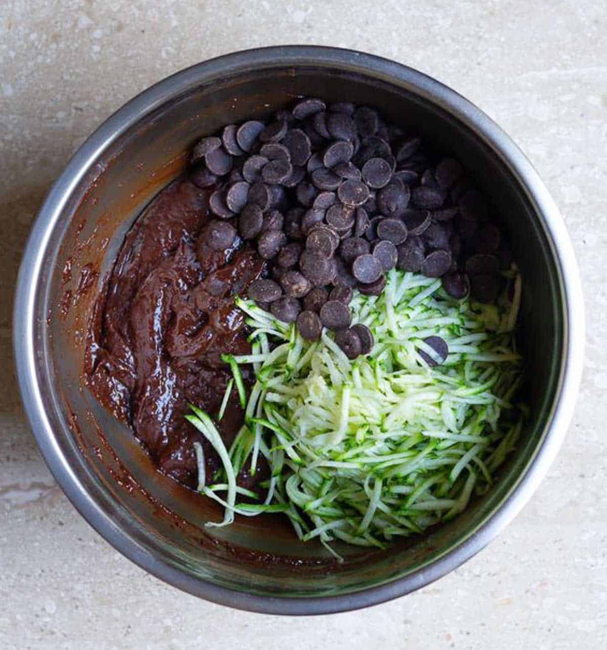 chocolate chips and shredded zucchini on chocolate cake batter.