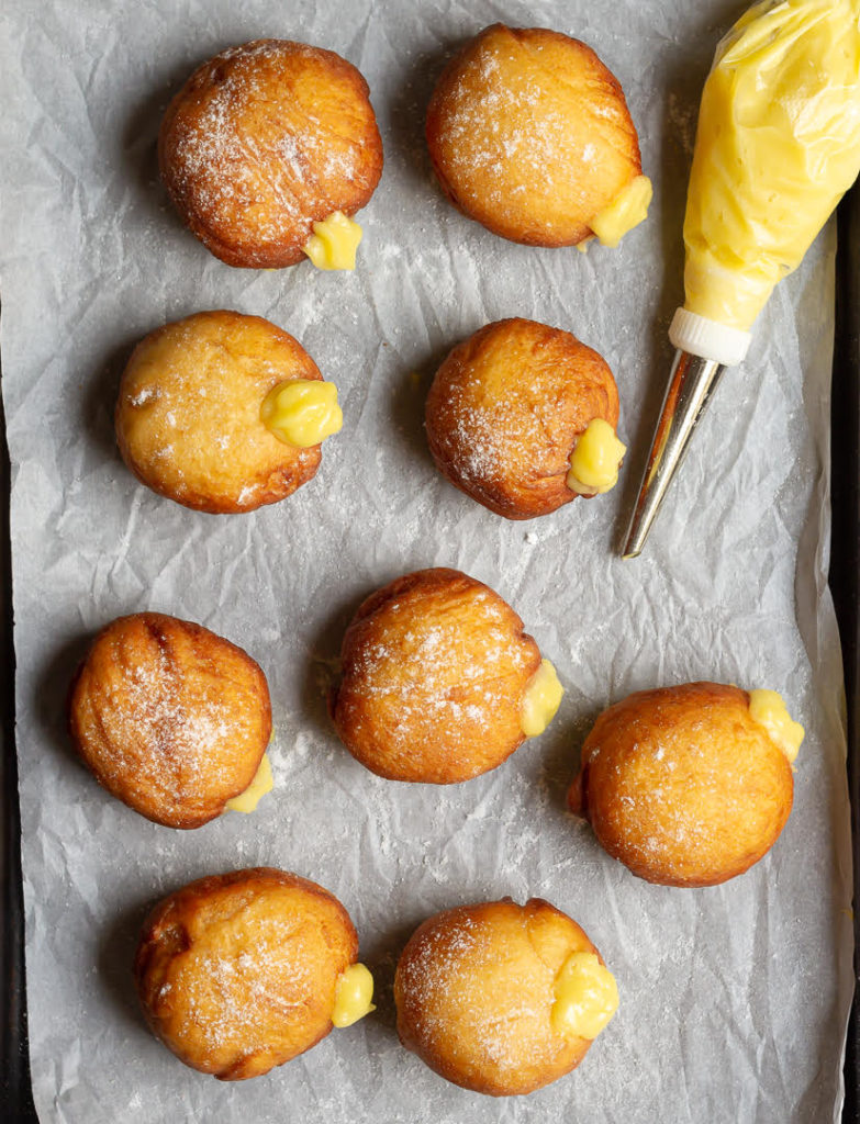 Filling the donuts with mango curd
