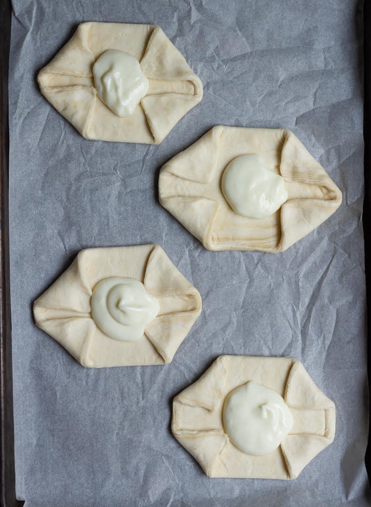 Spoon cream cheese filling in the center of the pastry