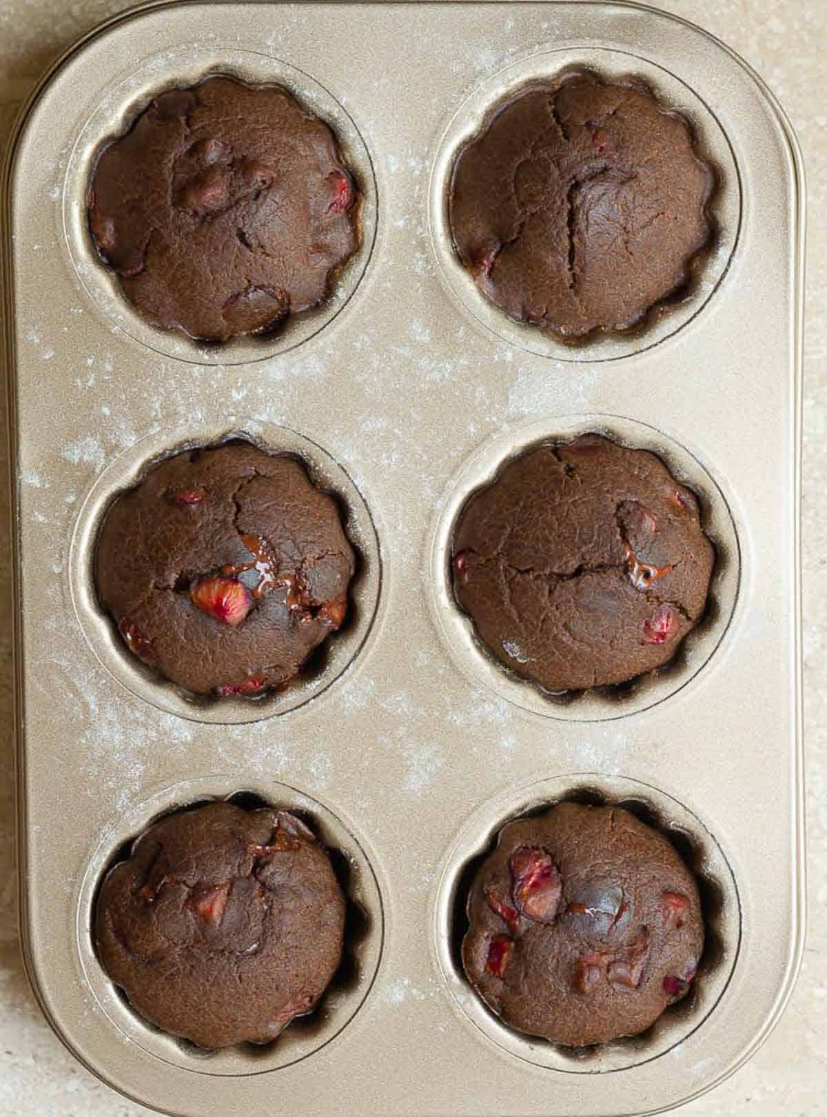 Baked chocolate madeleines with cherries.
