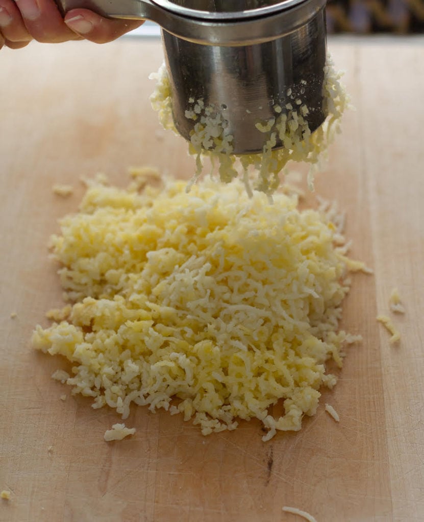 Mash potatoes using potato ricer