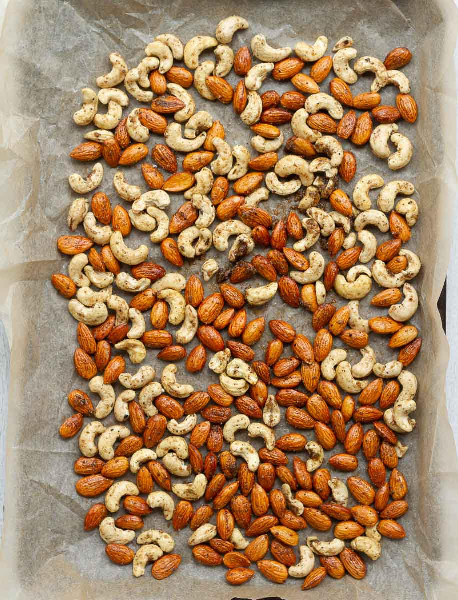 Spread the nuts, coated in masala, on a tray