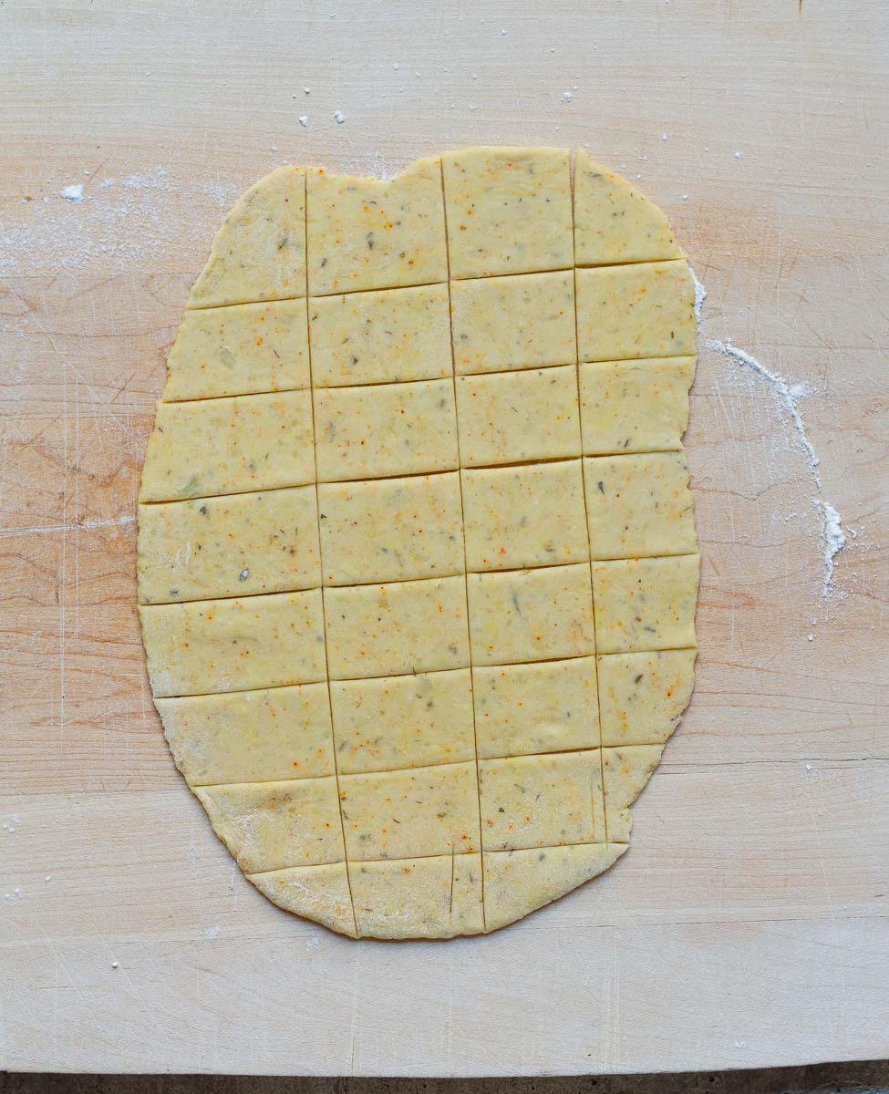 Roll out each dough piece into a rough rectangle and cut into small squares