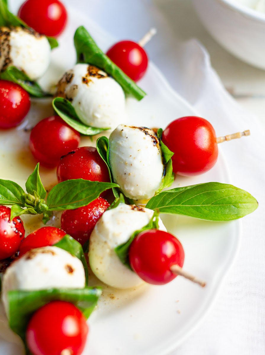 Caprese Salad Skewers on a white serving platter.