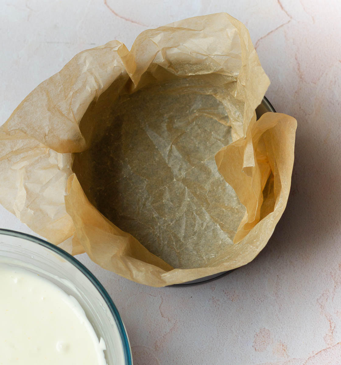 Line the cake tin with parchment paper
