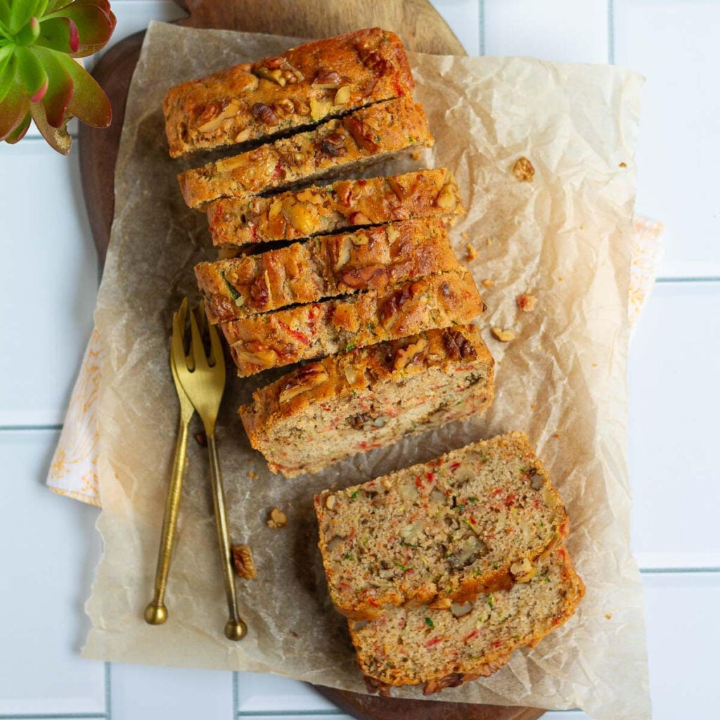 Carrot Zucchini Bread on parchment paper lined board with 2 forks.