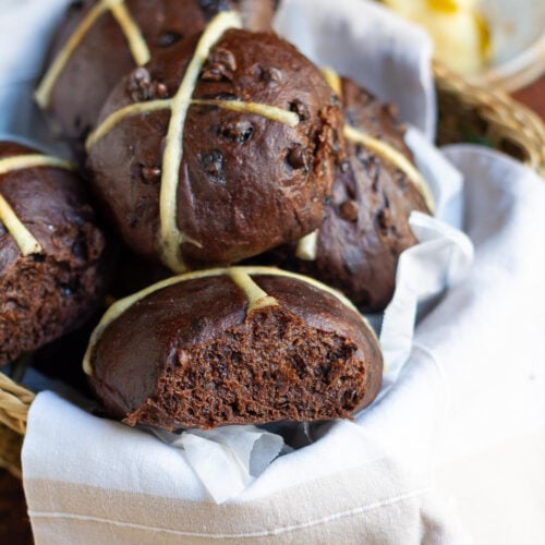Chocolate Hot Cross Buns in a napkin lined basket.