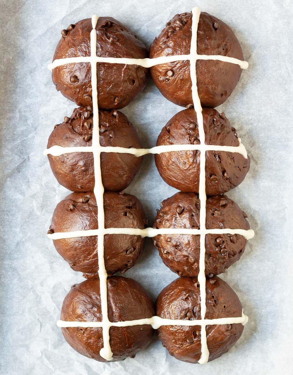 Risen dough balls with flour paste cross piping on top