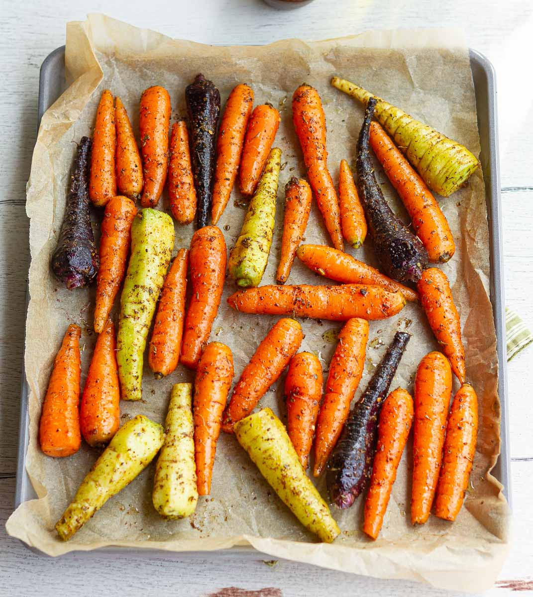 Seasoned carrots on a baking tray