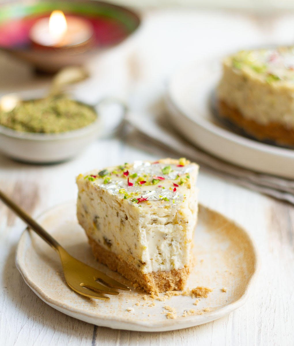 Slice of cheesecake on a plate with a fork on the side.