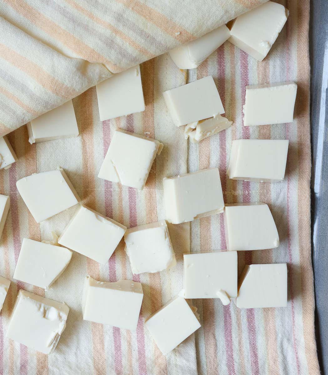 Cubes of tofu wrapped in kitchen towels