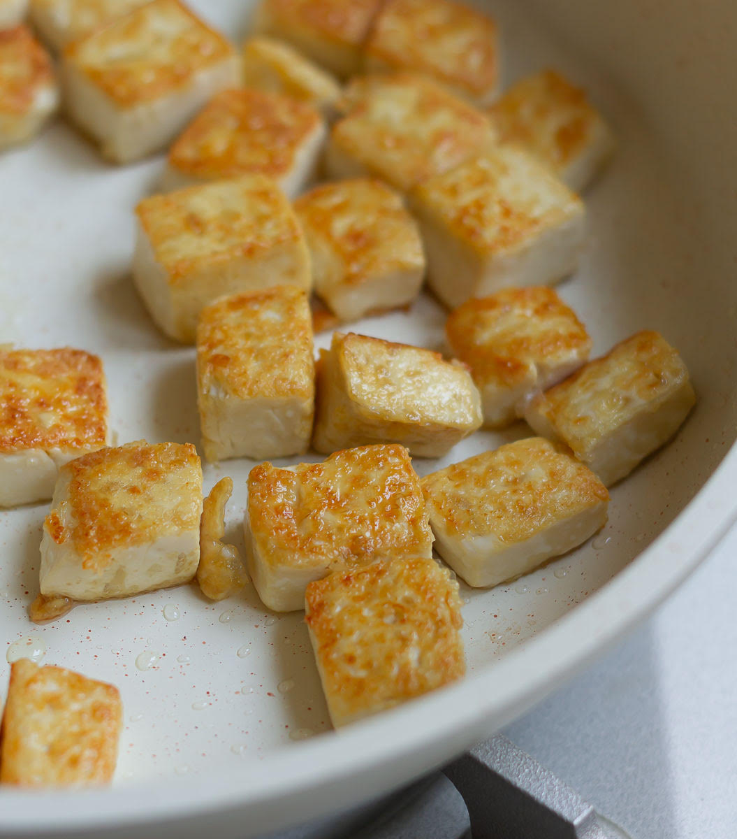 Crispy pan-fried tofu in a skillet