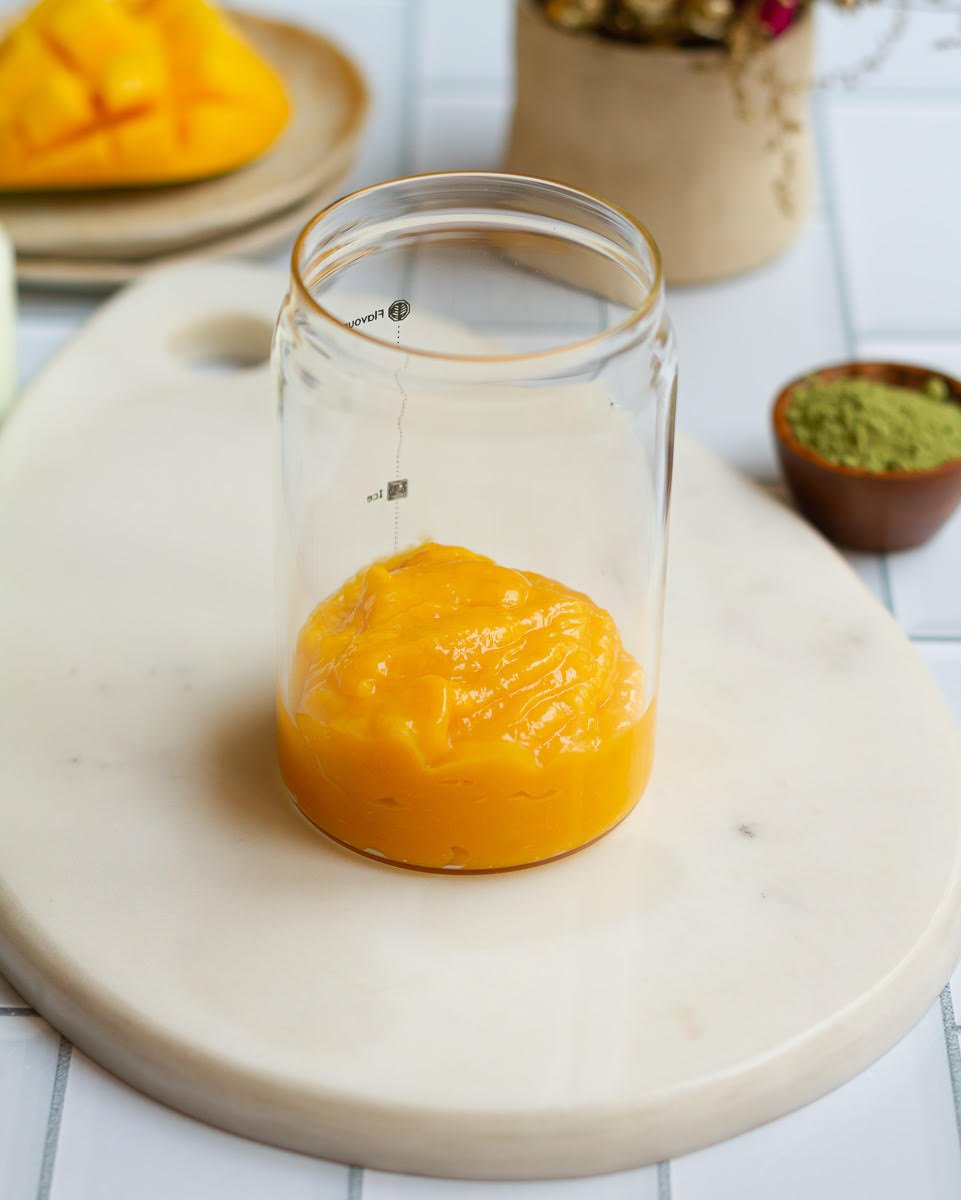 Mango puree in a glass.