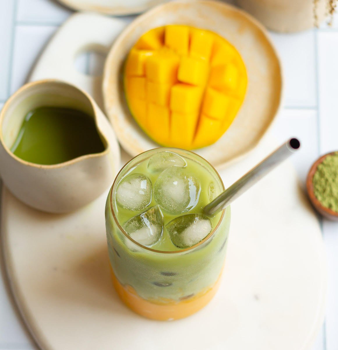  Mango Matcha Latte in a glass with a steel straw.