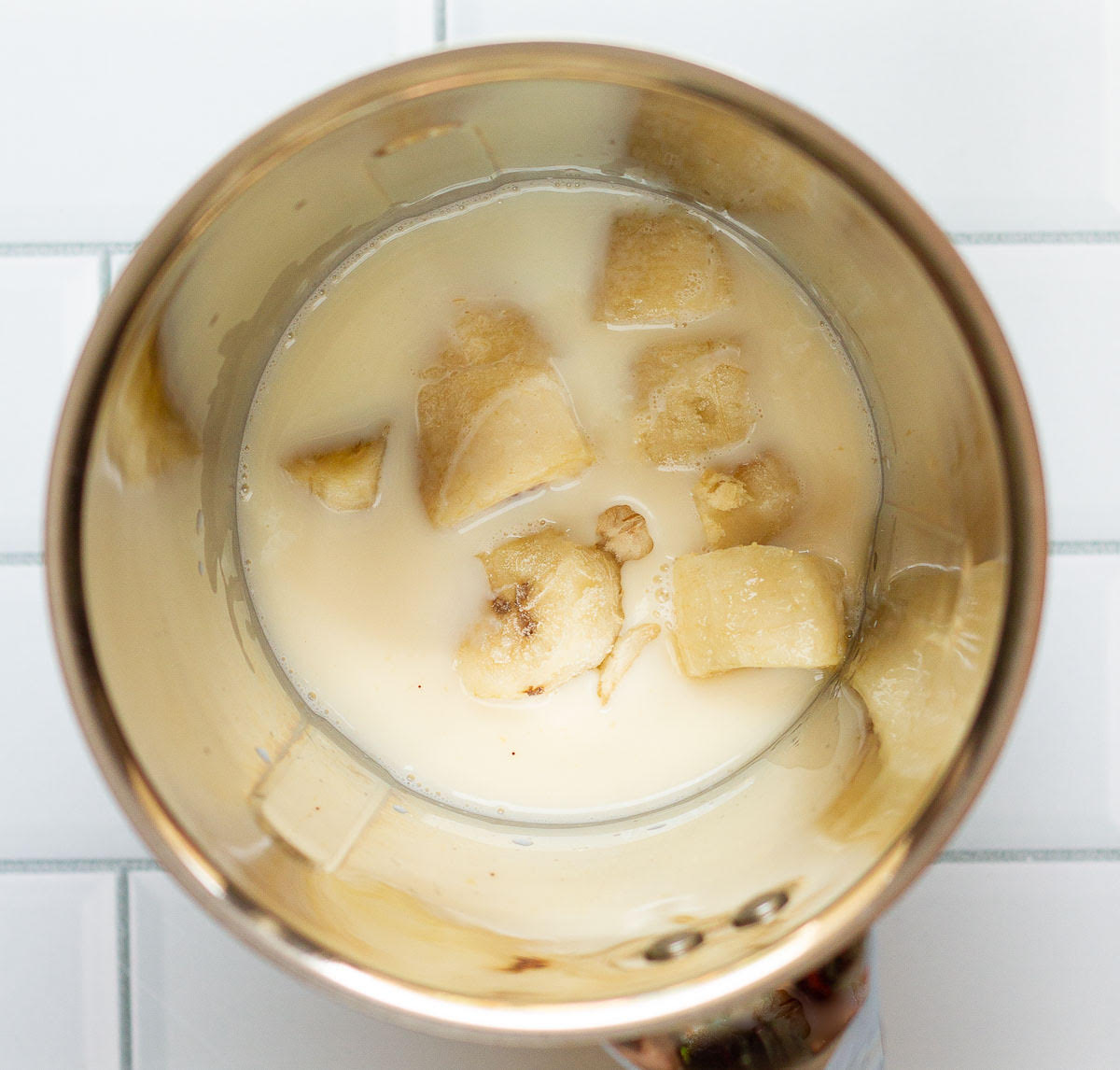Banana, milk, sugar and vanilla extract in a blender