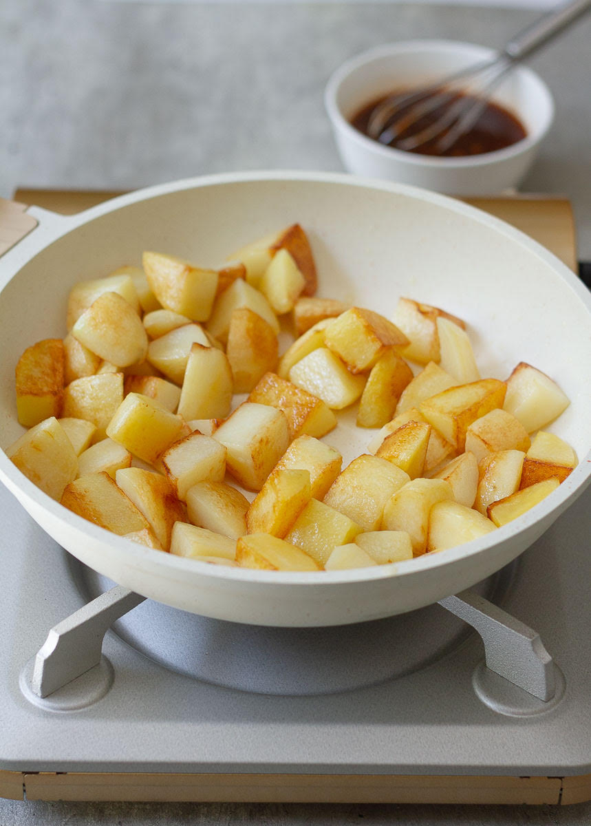 Golden crispy potatoes in a skillet