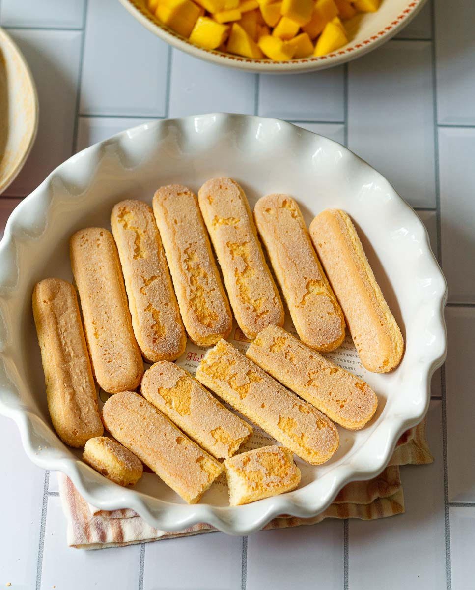 Layer the bottom of the dish with ladyfinger cookies.