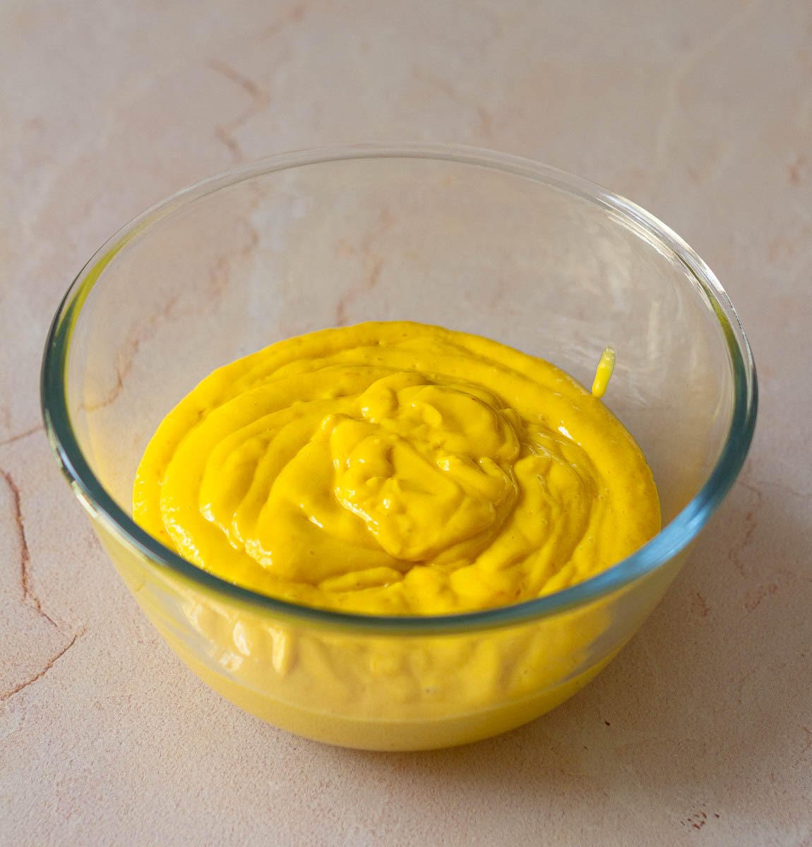 Blended mango, coconut milk, and sugar mixture in a bowl