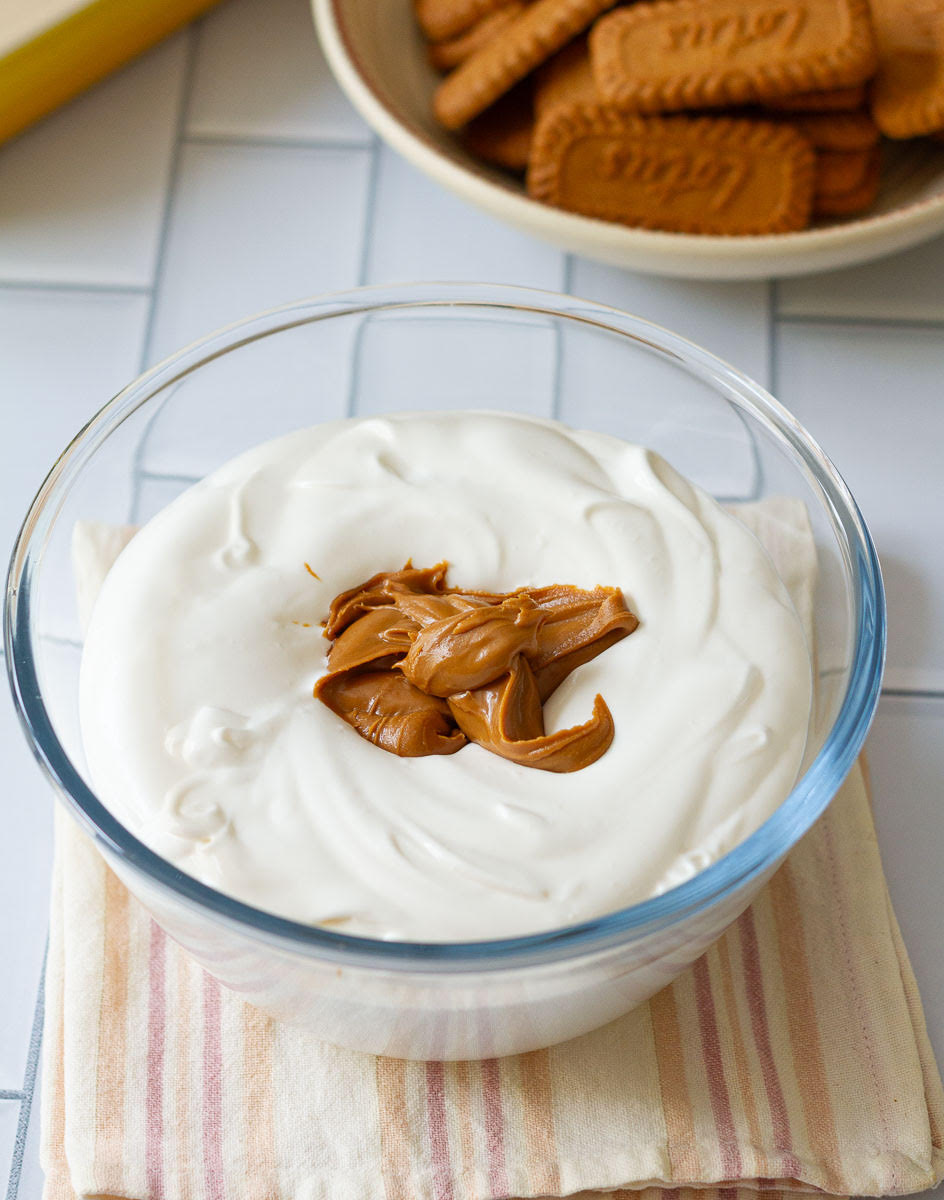 Biscoff spread in a bowl of whipped cream