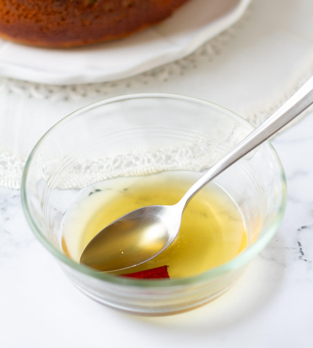 Syrup for the cake in a small bowl