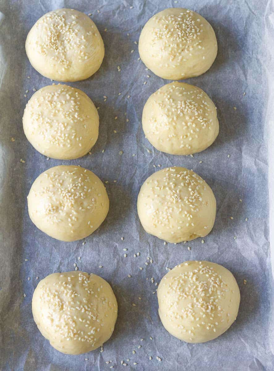 dough balls brushed with egg wash and sesame seed sprinkles