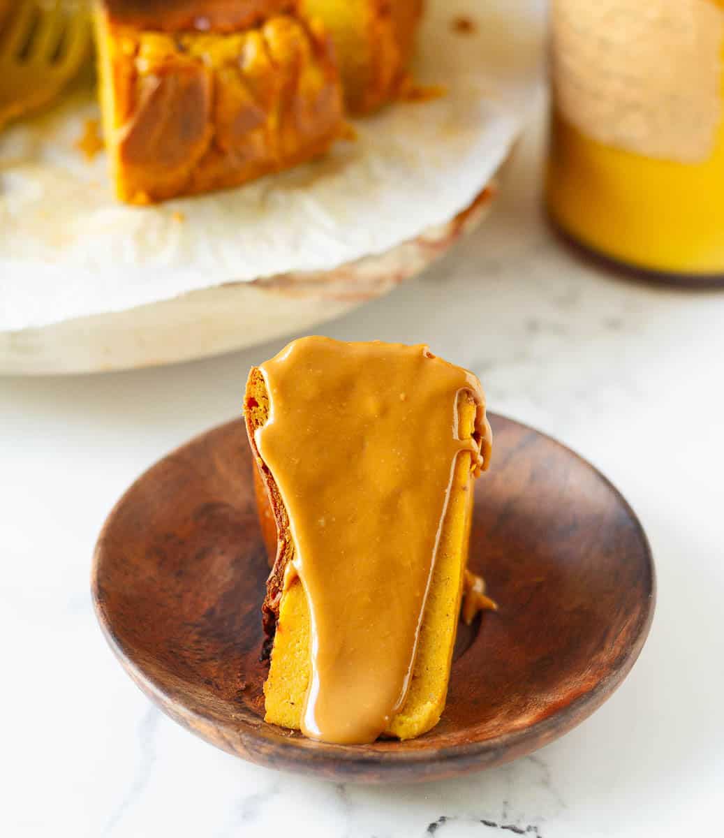 Slice of pumpkin basque cheesecake with melted biscoff spread
