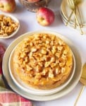 Apple cake on a platter with ingredients around.