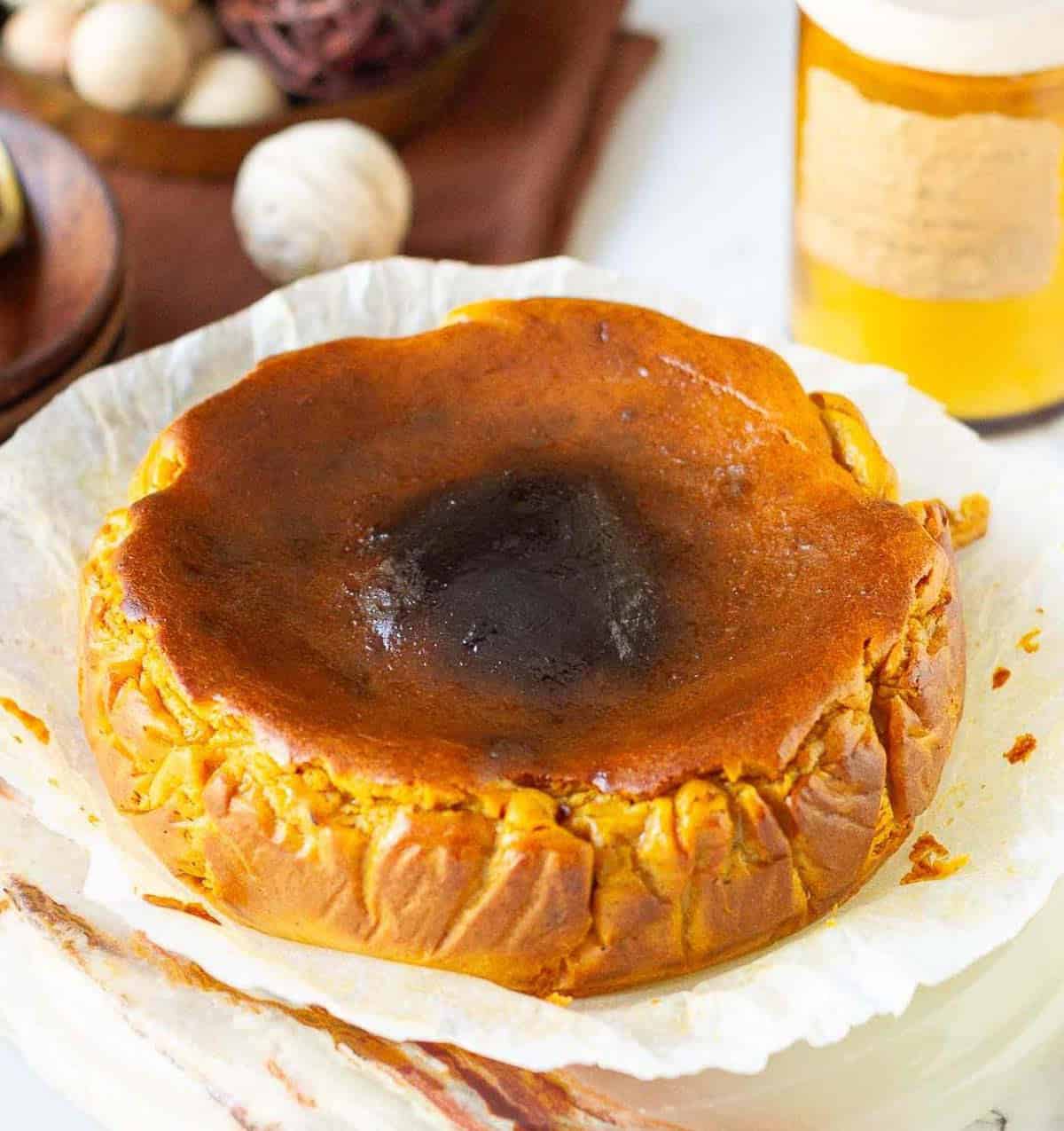 Pumpkin basque cheesecake on parchment paper.