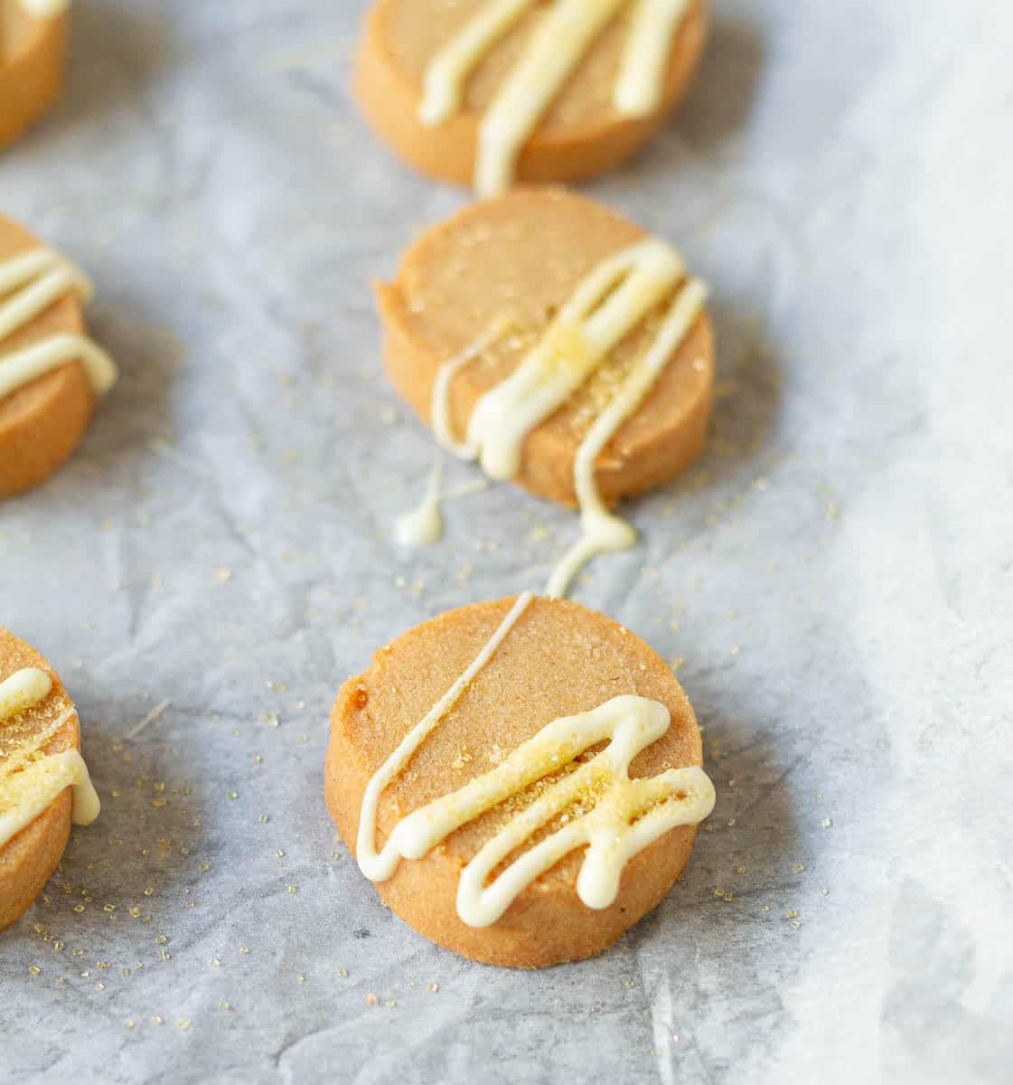 Drizzle the cookies with melted white chocolate and sugar sprinkles