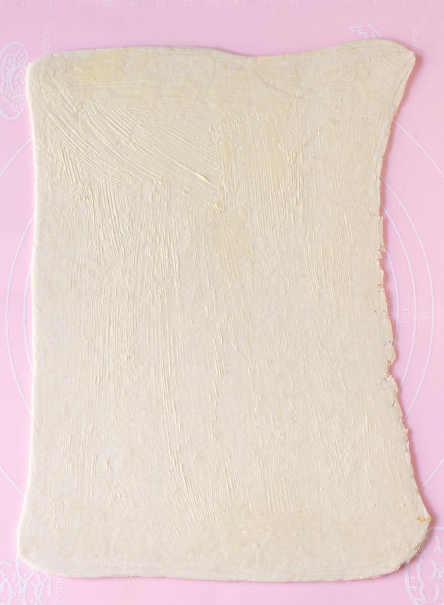 Rolled out puff pastry brushed with butter.