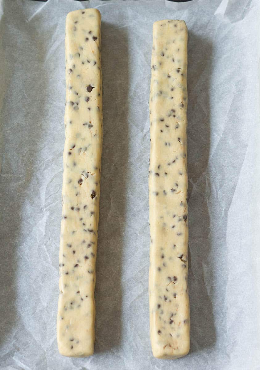 cookie dough divided in half and rolled into logs