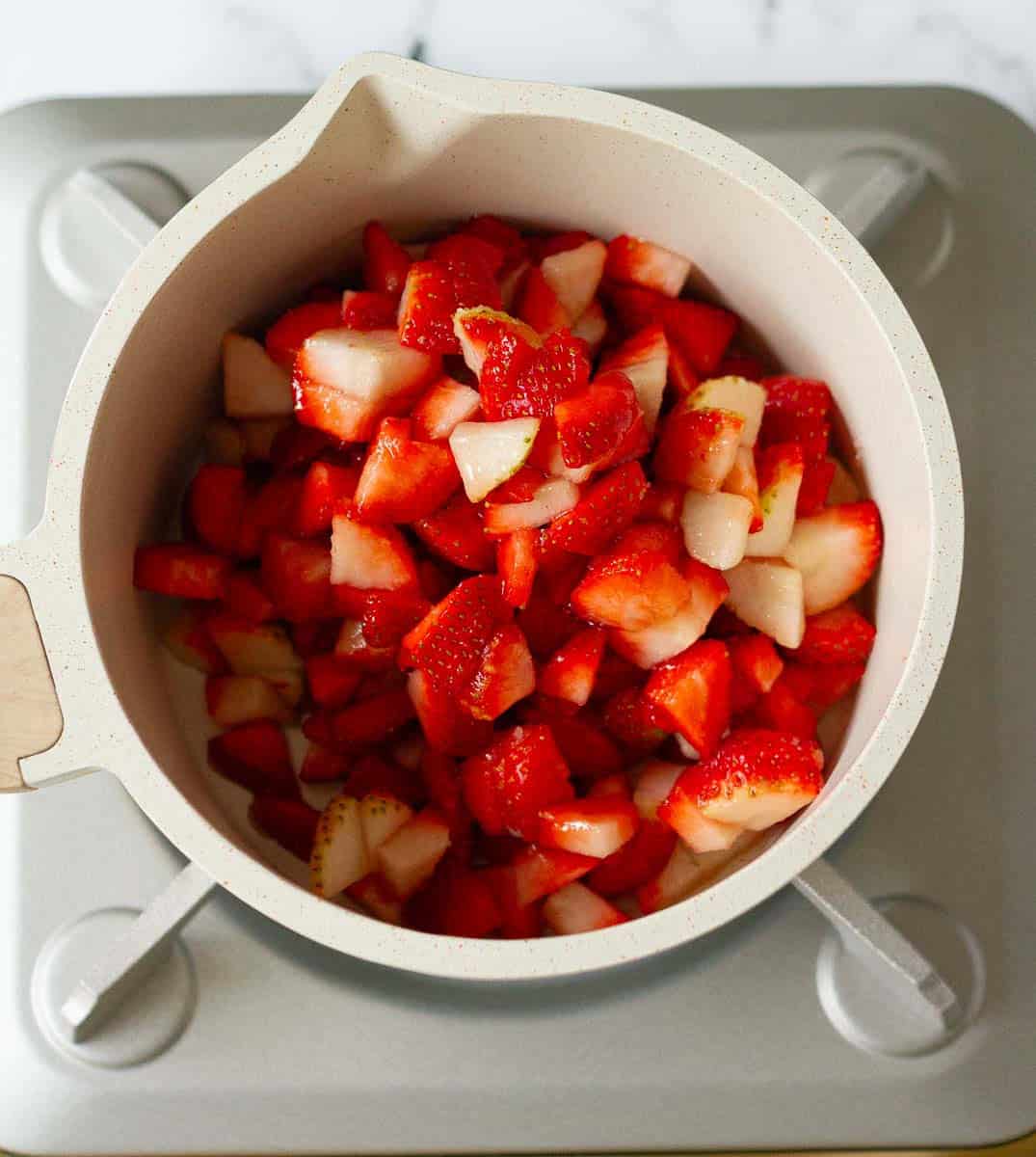 strawberry and sugar mixture in a saucepan