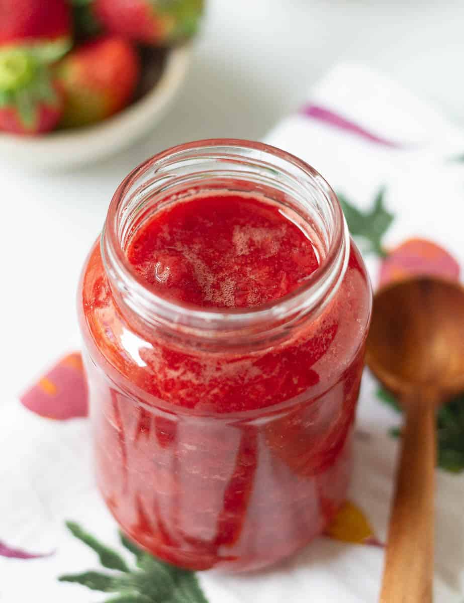 cooled strawberry syrup in a glass jar