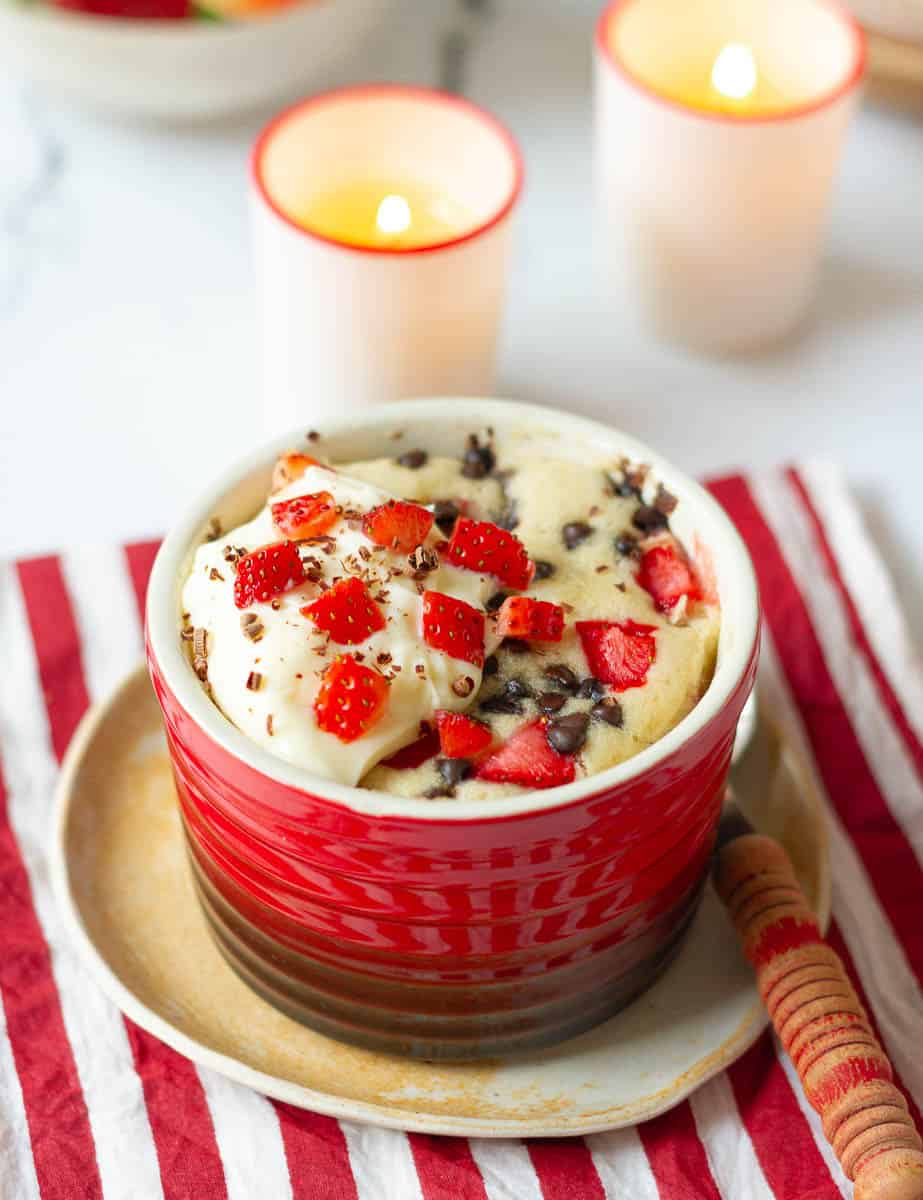  Strawberry Mug Cake topped with mascarpone cheese frosting and chocolate shavings