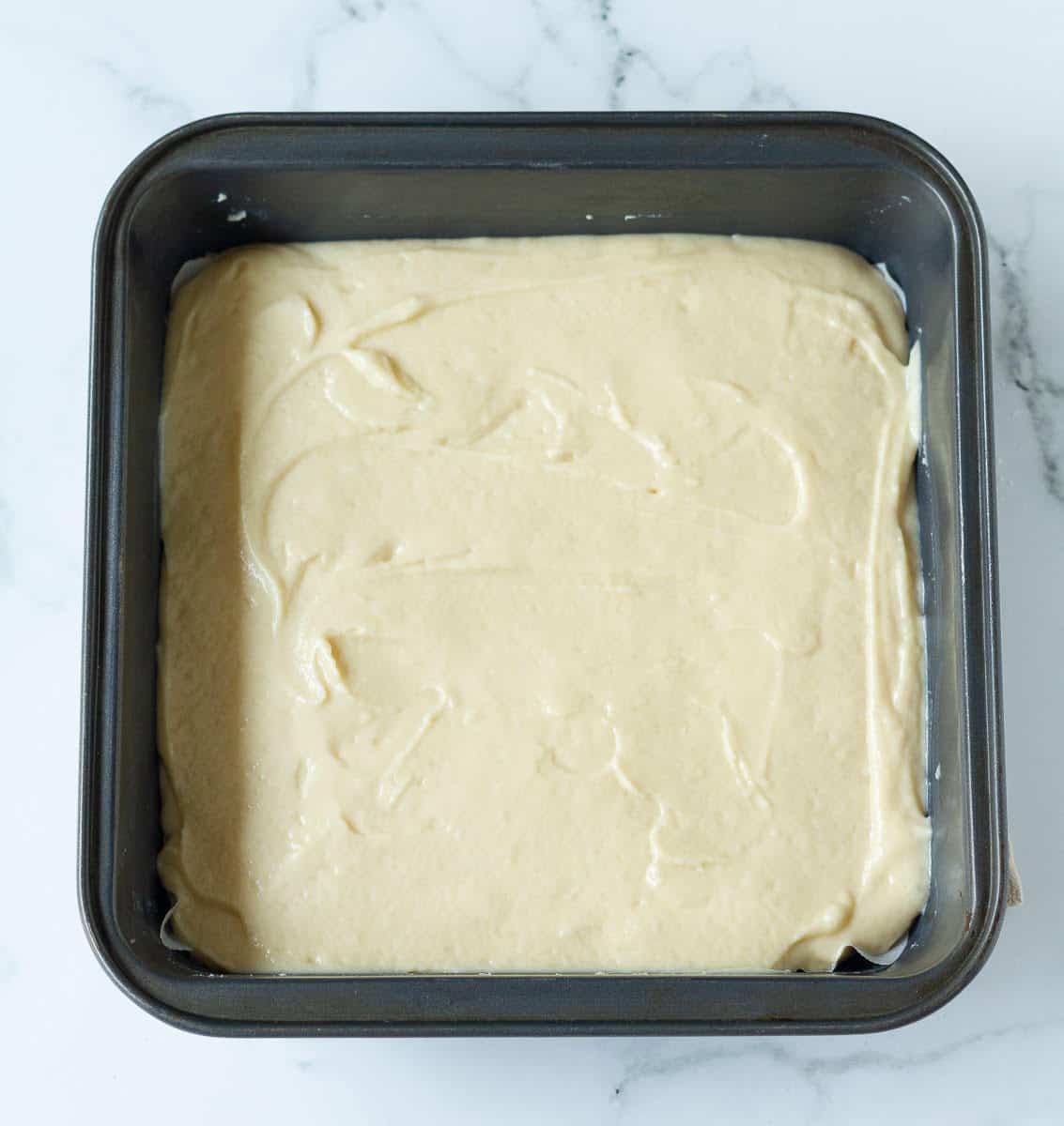 cake batter in a square baking tin